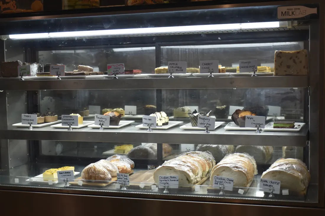 The cake cabinet with slices and sweet treats
