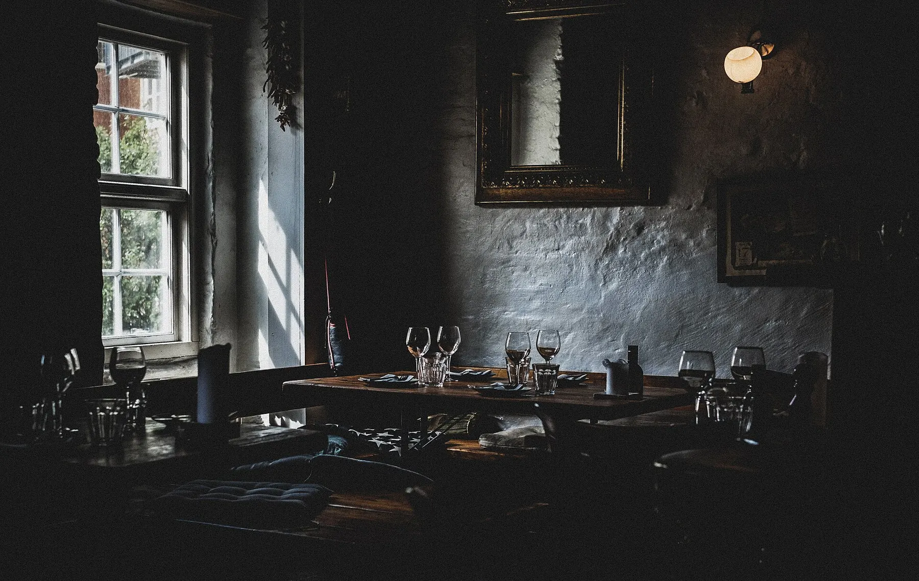 A softly lit dining room set for dinner