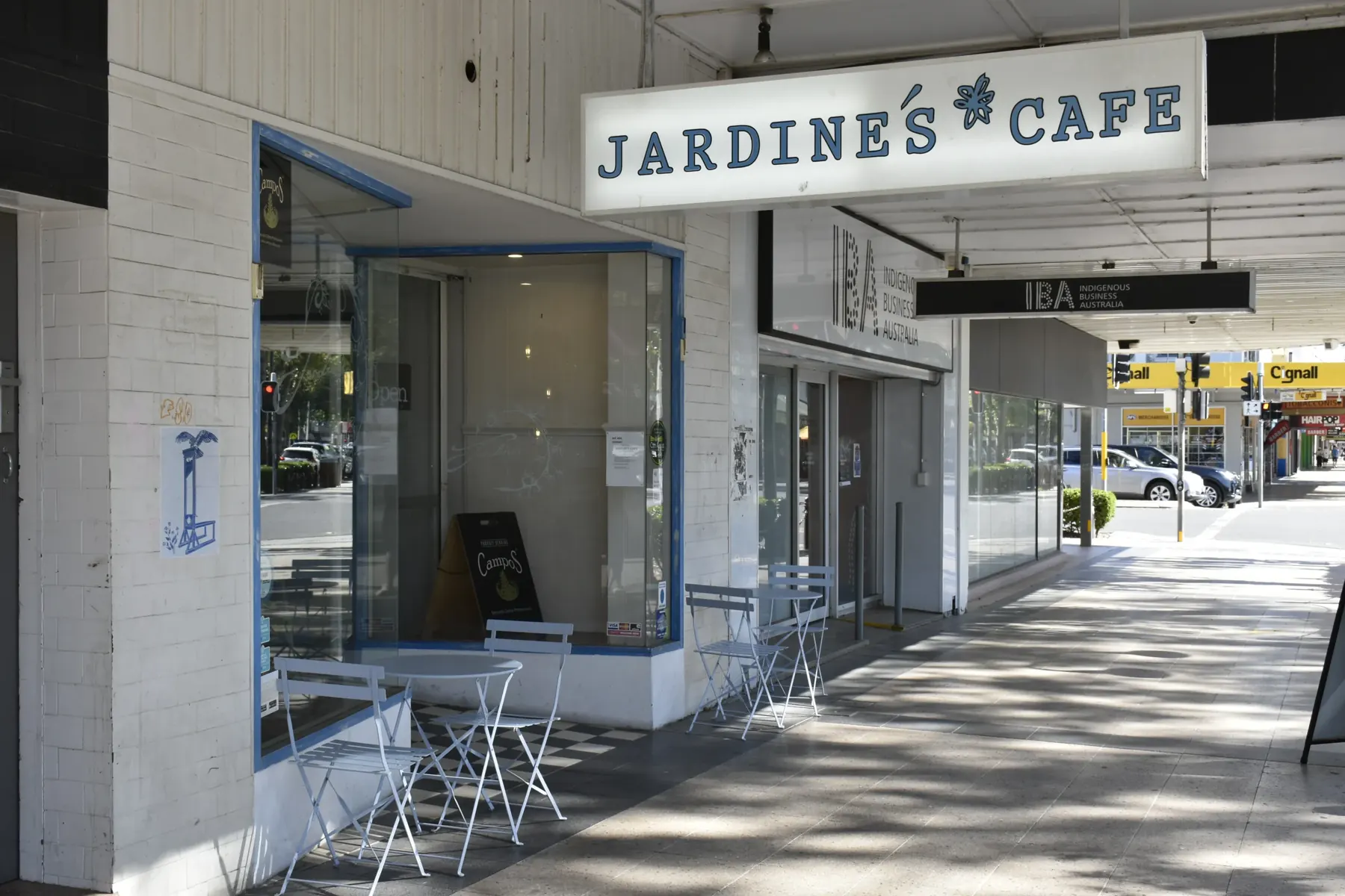 Jardine’s Cafe shopfront on Baylis Street, with tables on the footpath